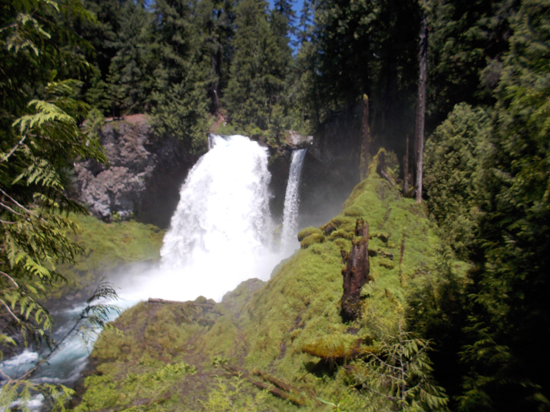 Sahalie Falls thundering over a lava ledge into a blue pool on the McKenzie River